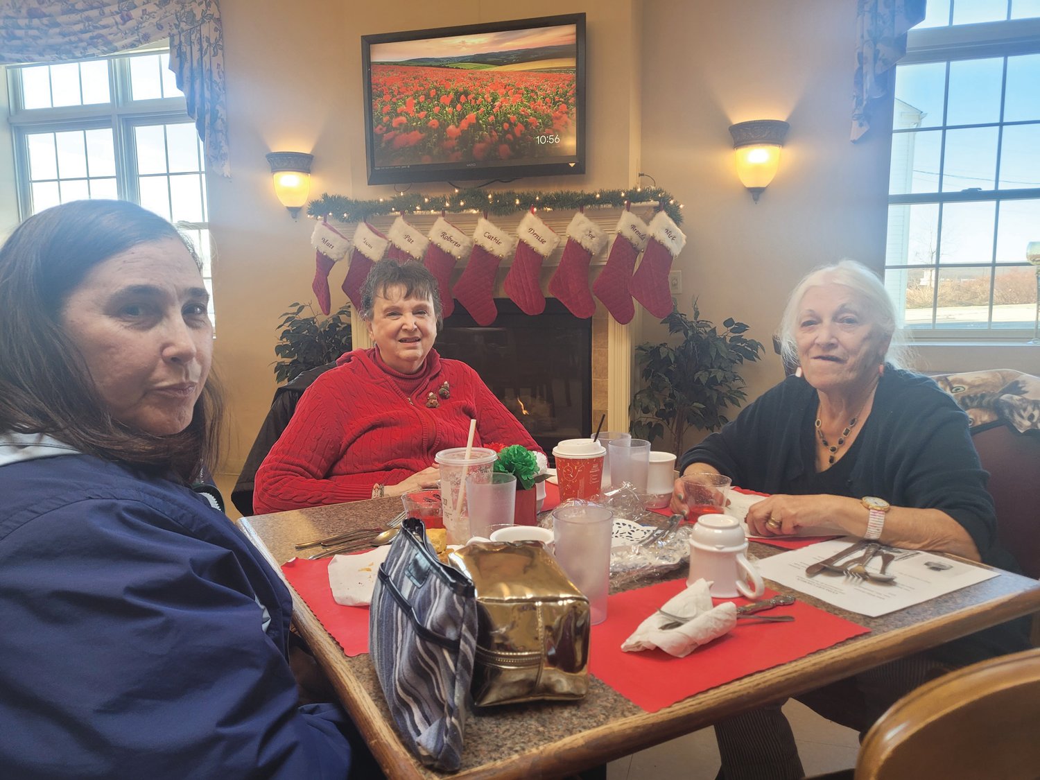 HOLIDAY SMILES: Dawn Renzi, Pat Baxter and Gloria Renzi anxiously awaited the afternoon’s entertainment.